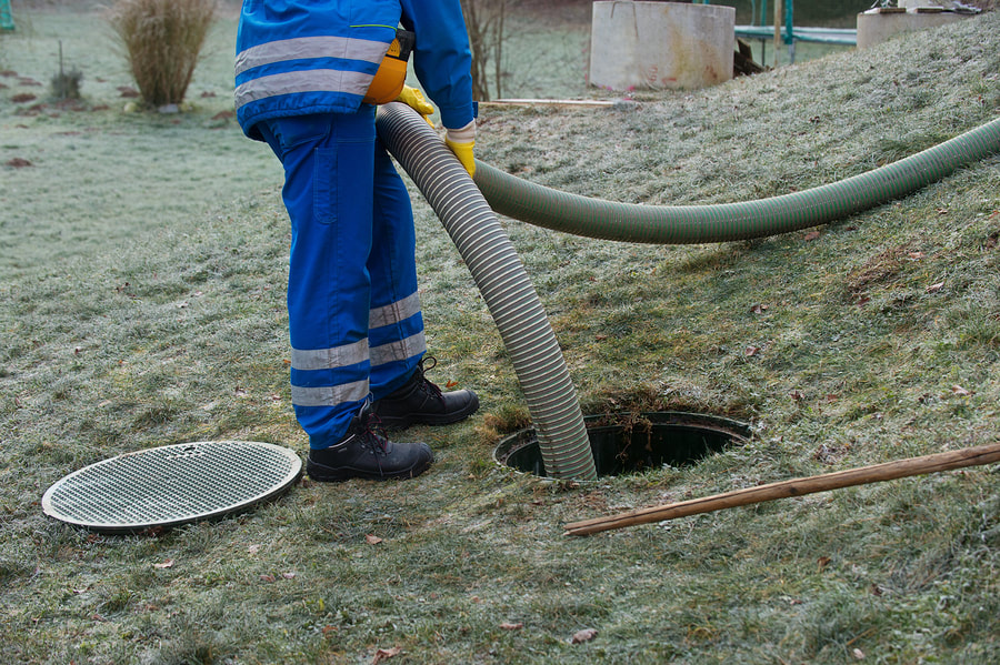 septic system worker doing septic pumping