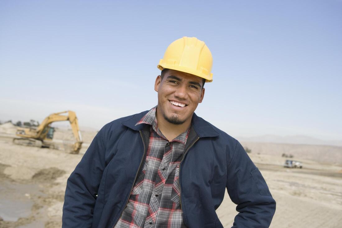 man smiling posing at construction site