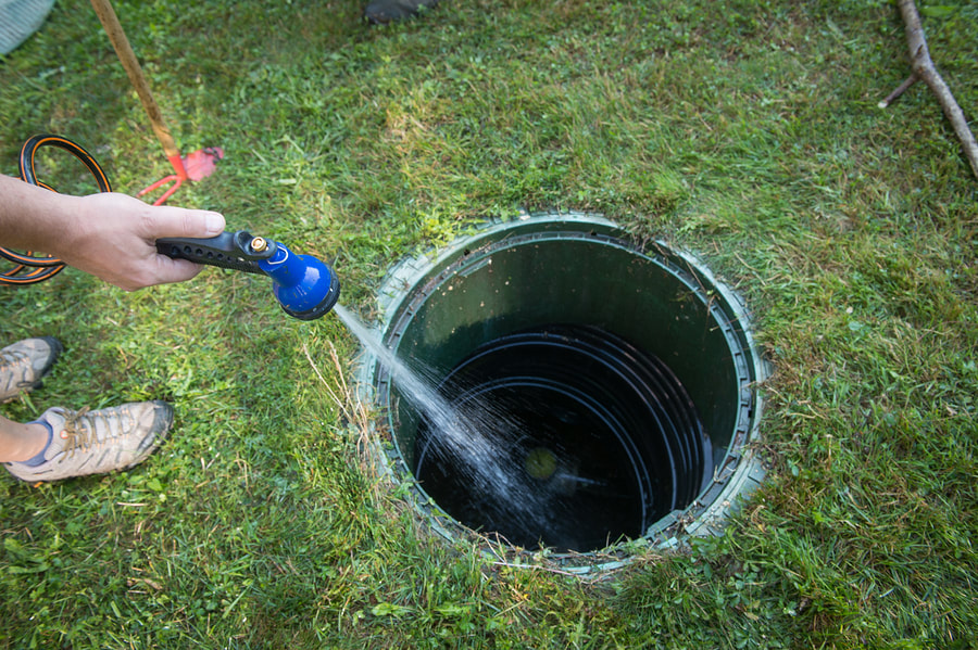 septic system worker doing septic pumping 